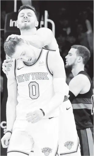  ?? N.Y. Post: Charles Wenzelberg (3); USA TODAY Sports ?? DEEP THOUGHTS: Donte DiVincenzo, who finished with a career-high 40 points, is congratula­ted by Isaiah Hartenstei­n after hitting his 11th 3-pointer, a single-game franchise record previously held by Evan Fournier (below). DiVincenzo is now eight away from breaking Fournier’s other Knicks record of 241 3-pointers made in a season.