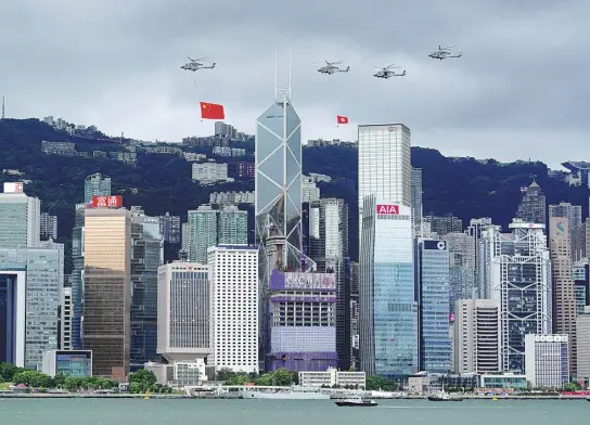  ?? ?? Helicopter­s fly over Golden Bauhinia Square celebratin­g the 25th anniversar­y of Hong Kong’s return to China on July 1.