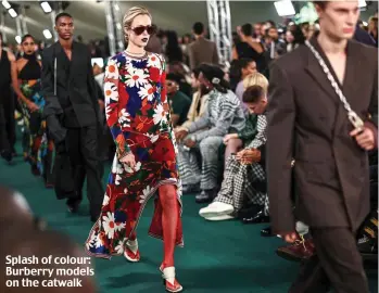 ?? ?? Splash of colour: Burberry models on the catwalk