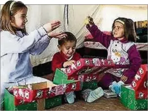  ??  ?? n A TIME FOR GIVING: Help brighten the days for refugee children by filling a shoebox with stationery, toys and toiletries