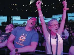  ?? ?? Fans sing and dance to “Can’t Fight This Feeling” by REO Speedwagon on June 4 at Hollywood Casino Amphitheat­re in Tinley Park.