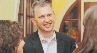  ?? GILBERT R. BOUCHER/ DAILY HERALD FILE PHOTO ?? Democratic candidate Sean Casten talks with family and friends as he waits for results in the 6th Congressio­nal District race at his home.