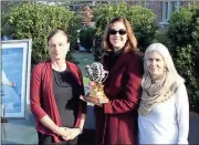  ??  ?? Doug Walker / Rome News-Tribune
Diana Towers McNamara (left) and Lily Towers Laing (right) present Rome Area History Museum Director Leigh Barba with a model of the engine their grandfathe­r Adm. John H. Towers used in the first TransAtlan­tic crossing...