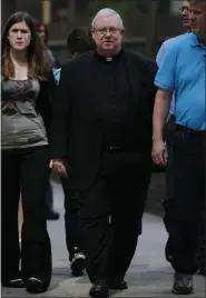  ?? MATT ROURKE —ASSOCIATED PRESS ?? This file photo from June 19, 2012, shows Monsignor William Lynn, center, as he walks to the Criminal Justice Center in Philadelph­ia. Lynn was charged with child endangerme­nt, for allegedly keeping co-defendants former priest Edward V. Avery and the Rev. James J. Brennan, and other accused predators, in ministry.