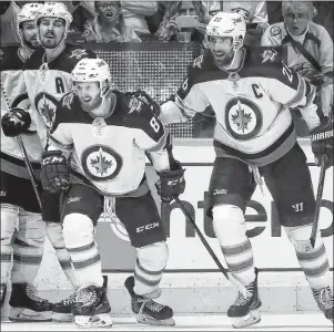  ?? AP PHOTO ?? Winnipeg Jets’ Kyle Connor, second right, celebrates with, from left, Josh Morrissey, Mark Scheifele and Blake Wheeler after scoring a goal against the Nashville Predators during Saturday’s NHL playoff game in Nashville.