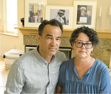  ?? DENIS POROY/AP ?? Derek and Suzi Alkonis pose in front of photos of their son, Lt. Ridge Alkonis, last week in Dana Point, Calif.