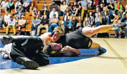  ?? STAFF PHOTOS BY ROBIN RUDD ?? Soddy-Daisy’s Ty Boeck, top, works to pin Bradley Central’s Kevin Gentry at 220 pounds on Tuesday at the Soddy-Daisy Wrestling Arena.