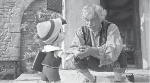  ?? DISNEY ?? Geppetto ( Tom Hanks, right) cares for his beloved wooden creation ( voiced by Benjamin Evan Ainsworth) in Disney’s live- action “Pinocchio.”