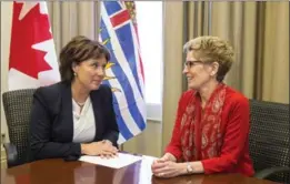  ?? CHRIS YOUNG, THE CANADIAN PRESS ?? Premier Kathleen Wynne (right) meets with B.C. Premier Christy Clark in 2014. Clark is the only female premier in Canadian history to win re-election, but within a month she lost a non-confidence vote and was out of politics.