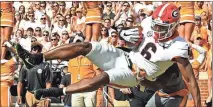  ?? Joy Kimbrough / The Daily Times via AP ?? Georgia wide receiver Javon Wims catches a touchdown pass during the first half of Saturday’s game against the Volunteers in Knoxville, Tenn.