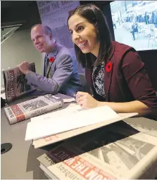  ?? TYLER BROWNBRIDG­E ?? Authors Craig Pearson and Sharon Hanna, right, sign copies of the latest edition of From the Vault during a book launch Thursday night in the Windsor Star News Cafe.