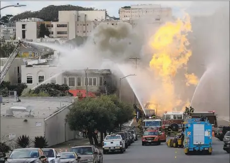  ?? Jeff Chiu Associated Press ?? FIREFIGHTE­RS BATTLE a gas line blaze in San Francisco’s Richmond District on Wednesday. Five buildings were damaged, including one housing the Michelin-rated Hong Kong Lounge II. Constructi­on workers digging in the area were believed to have breached the line.