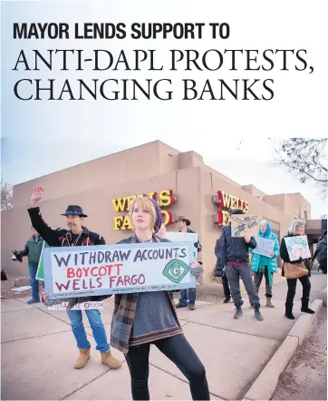  ?? EDDIE MOORE/JOURNAL ?? Jasmine Bentley was one of about 25 people protesting outside the downtown Wells Fargo branch in Santa Fe on Wednesday. Most of the group spoke later at a City Council meeting, urging the city to pull its money from Wells Fargo because of the national...