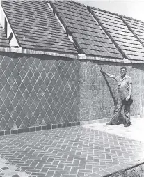  ?? CONTRIBUTE­D PHOTO ?? A worker stands by a display of porcelain tile manufactur­ed at the Hood Tile Co. in Daisy.