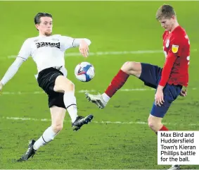  ??  ?? Max Bird and Huddersfie­ld Town’s Kieran Phillips battle for the ball.