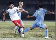  ?? RECORDER PHOTO BY CHIEKO HARA ?? Monache High School’s Carlos Magana, right, steals a ball from Lindsay High School’s Emiliano Corona, left, as Fabio Melgar puts pressure on Corona Tuesday, Nov. 20, during the second half of a game at Monache High School.