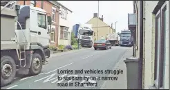  ??  ?? Lorries and vehicles struggle to squeeze by on a narrow road in Sharnford