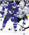  ??  ?? Maple Leafs centre John Tavares battles for the puck with Kings winger Tyler Toffoli on Monday.