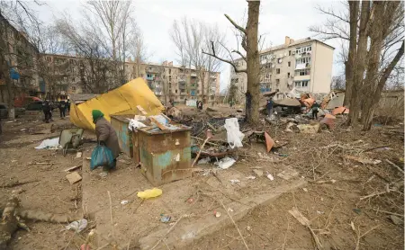  ?? ANDRIY DUBCHAK/AP ?? After a Russian missile attack Saturday, a woman walks in a residentia­l area of Kostiantyn­ivka, Ukraine.