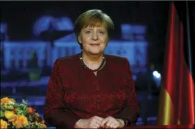  ?? PHOTO/HANNIBAL HANSCHKE ?? German acting Chancellor Angela Merkel poses for photograph­s after the television recording of her annual New Year’s speech at the Chanceller­y in Berlin, Germany on Saturday. AP