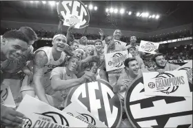  ?? AP/BRYNN ANDERSON ?? Auburn players celebrate after beating South Carolina 79-70 on Saturday. The victory allowed the Tigers to clinch a share of the SEC regular-season title with Tennessee. When the preseason poll was released in October, Auburn was picked to finish ninth...