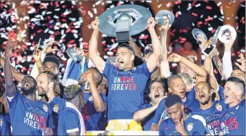  ??  ?? Monaco players hold the trophy as they celebrate their French League One title after beating Saint Etienne at the Louis II stadium in Monaco.