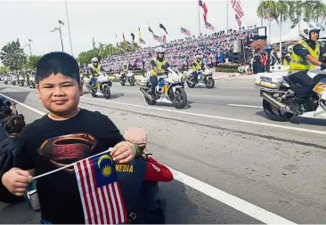  ??  ?? Unforgetab­le outing: Hafiy enjoying his day during the National Day parade in Kota Kinabalu.