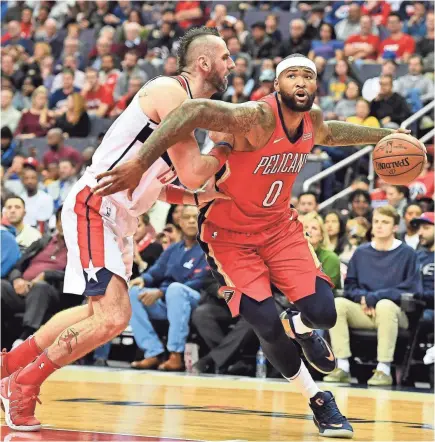  ?? BRAD MILLS/USA TODAY SPORTS ?? DeMarcus Cousins (0), driving against Marcin Gortat last season, was averaging 25.2 points and on pace to set career highs in rebounds (12.9 per game) and assists (5.4) for the Pelicans before he was injured last season.