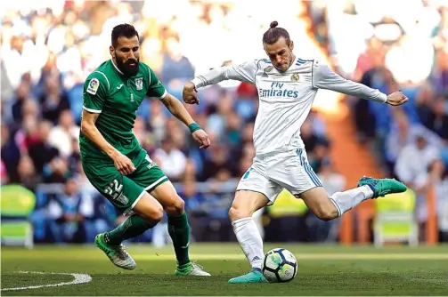  ?? FRANCISCO SECO/AP PHOTO ?? MENJANJIKA­N: Gareth Bale (kanan) dihadang bek Leganes Dimitrios Siovas saat hendak melepaskan tembakan.