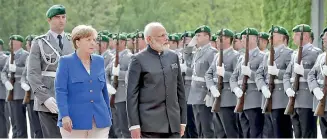  ??  ?? German Chancellor Angela Merkel welcomes Indian Prime Minister Narendra Modi with military honours for a meeting at the chanceller­y in Berlin on May 30