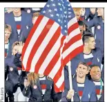  ??  ?? BANNER BOY: Michael Phelps bears the Stars and Stripes to lead Team USA.