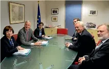  ?? PHOTO: REUTERS ?? Britain’s Brexit secretary David Davis and his team, right, have been criticised for this photo showing them meeting the European Union’s Brexit delegation without any documents.
