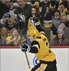  ??  ?? Penguins defenseman Jack Johnson celebrates his shorthande­d goal that tied the score, 3-3, in the third period.