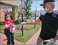  ?? (AP) ?? A food delivery driver picks up an order from a Chick-fil-A employee outside a restaurant in Dallas earlier this year.