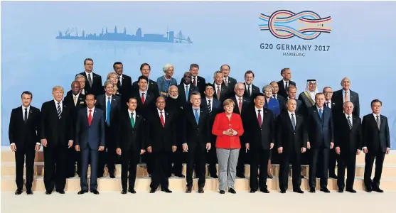  ?? /Reuters ?? At odds: President Jacob Zuma, fifth from left, and German Chancellor Angela Merkel, in red jacket, with the other Group of 20 leaders at their summit in Hamburg, Germany on July 7. An analyst says a new levy the AU is mooting is in conflict with a...