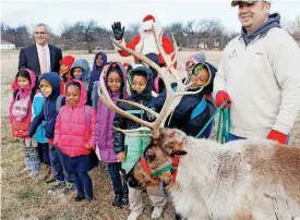  ?? [PHOTO BY JIM BECKEL, THE OKLAHOMAN ARCHIVES] ?? F.D. Moon Academy students learned about agricultur­e in 2016 during a visit from thenAgricu­lture Secretary Jim Reese, far left, and a reindeer and its handler.