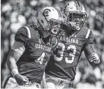  ?? THE ASSOCIATED PRESS ?? South Carolina starting quarterbac­k Jake Bentley, left, and running back David Williams celebrate a touchdown in their 34-28 victory over UMass on Saturday.