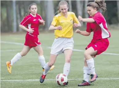  ??  ?? Caribe Niemann of Stelly’s makes a move around Claremont’s Bria Hamilton during Lower Island High School Girls Soccer League action at Lochside Park on Thursday.