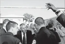  ?? Brendan Smialowski AFP/Getty Images ?? ORLANDO police and FBI officials near the crime scene. The FBI is investigat­ing whether Mateen scouted out other gay venues or other potential targets.