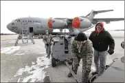  ?? LISA POWELL / STAFF ?? Airmen repair a fuel boost pump on a 445th Airlift Wing C-17 at Wright-Patterson Air Force Base in this 2013 file photo. The Air Force has said it has reduced a shortage of aircraft maintainer­s.