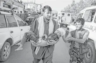  ?? Adam Ferguson photos / New York Times ?? An injured child is evacuated after a suicide bombing on Saturday targeted a demonstrat­ion by Hazaras, an ethnic minority group, in Kabul, Afghanista­n.