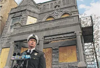  ?? | PHOTOS BY LESLIE ADKINS/ FOR THE SUN- TIMES ?? ABOVE: Fire District Chief Dan Cunningham on Monday at the building at 66th and Champlain. LEFT: A memorial for the children who died in the fire.