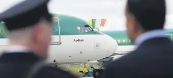  ?? ?? Airport staff looks at a plane parked on the tarmac, Dublin, Ireland, Aug. 26, 2018.