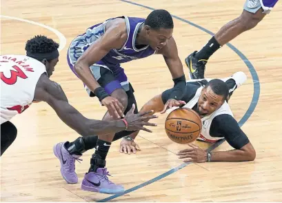 ?? RICH PEDRONCELL­I THE ASSOCIATED PRESS ?? Raptors Pascal Siakam, left, and Norm Powell — starting with Kyle Lowry unavailabl­e — battle the Kings’ De'Aaron Fox Friday night.