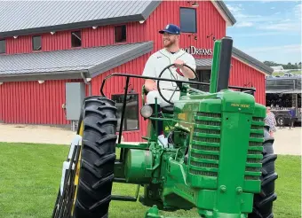  ?? Tribune News Service ?? Chicago Cubs reliever Rowan Wick poses on a tractor before the Field of Dreams game against the Cincinnati Reds on Thursday in Dyersville, Iowa.