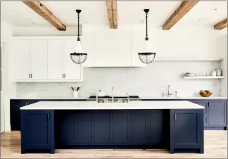  ?? JENNA PEFFLEY/BETSY BURNHAM VIA AP ?? This undated photo shows an urban farmhouse style kitchen in a Manhattan Beach, Calif., home designed by Betsy Burnham, where the kitchen island offers ample storage and an extra prep sink for use while cooking.