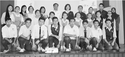  ??  ?? Ekni (standing centre) joins the AAY team from SMK Bandar Bintulu in a group photo after the launch.