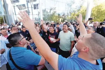  ??  ?? People sing during a prayer vigil, in honour of those affected by the shooting on the Las Vegas Strip, in front of Las Vegas City Hall in Las Vegas, Nevada, US, Oct 2. — Reuters/Las Vegas Sun/Steve Marcus photo