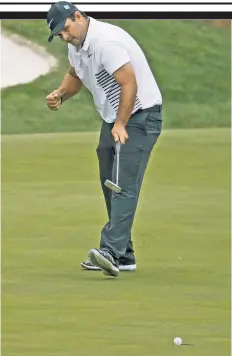  ?? AP ?? IT’S IN THE HOLE: Patrick Reed pumps his fist as his birdie putt drops on the 13th hole Friday.