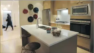  ??  ?? Kitchens include a premium appliance package and quartz countertop­s.